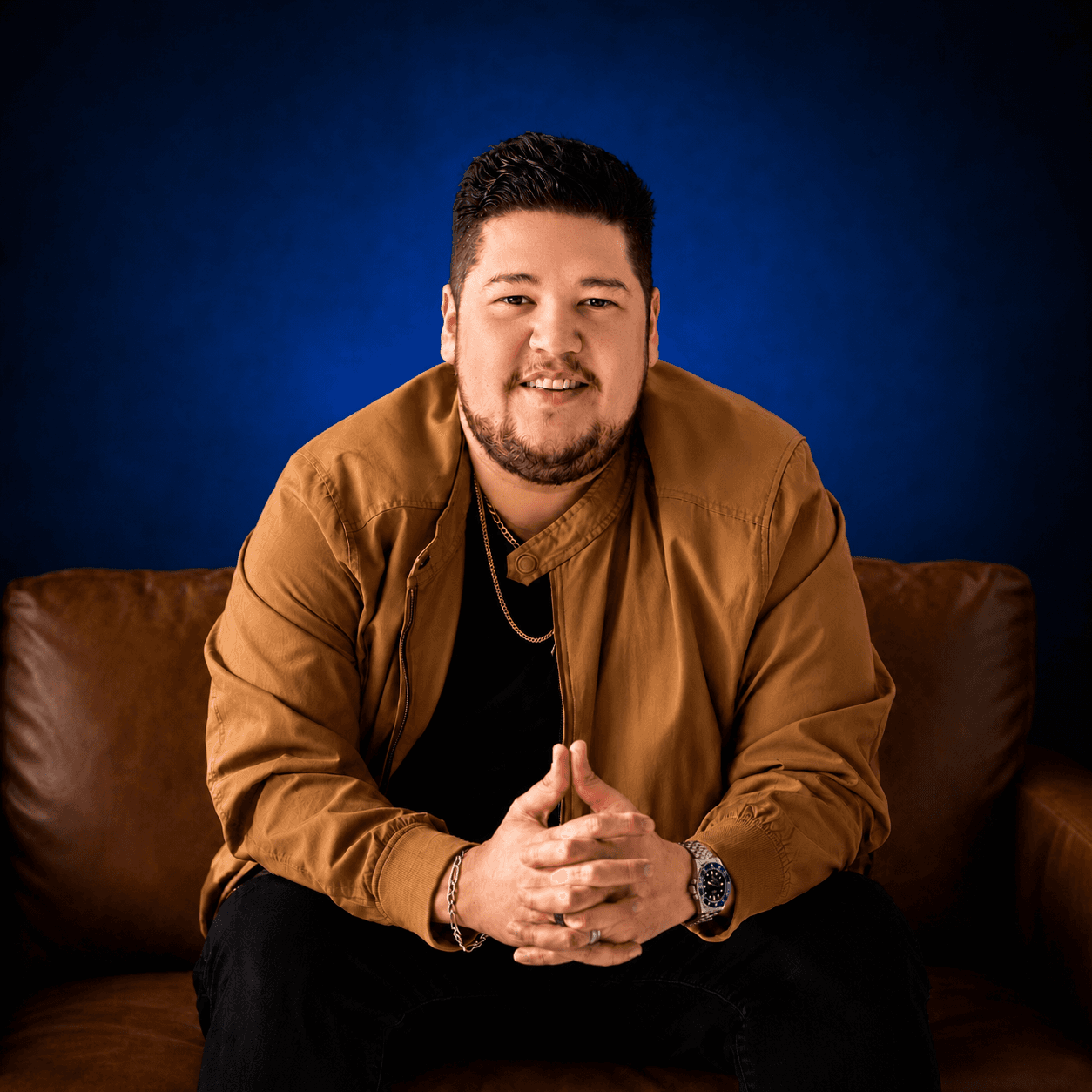 Dalton Speers, founder of STIX Marketing Advisors, seated on a leather couch