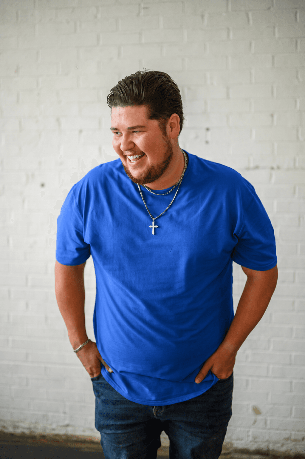 Dalton Speers, founder of STIX Marketing Advisors, laughing in a candid photo against a white brick wall